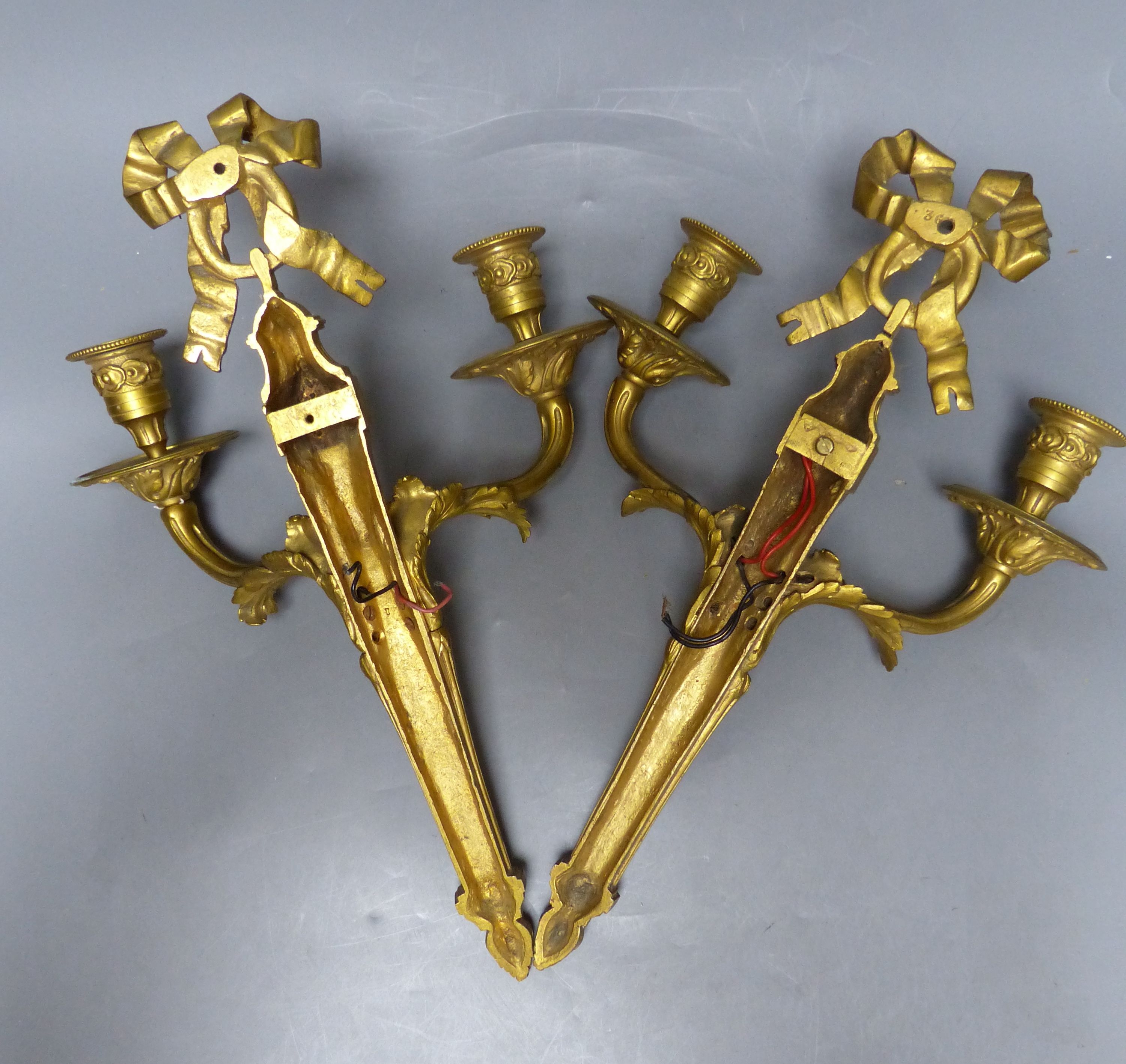 A pair of Louis XVI style ormolu two branch wall lights, height 39cm